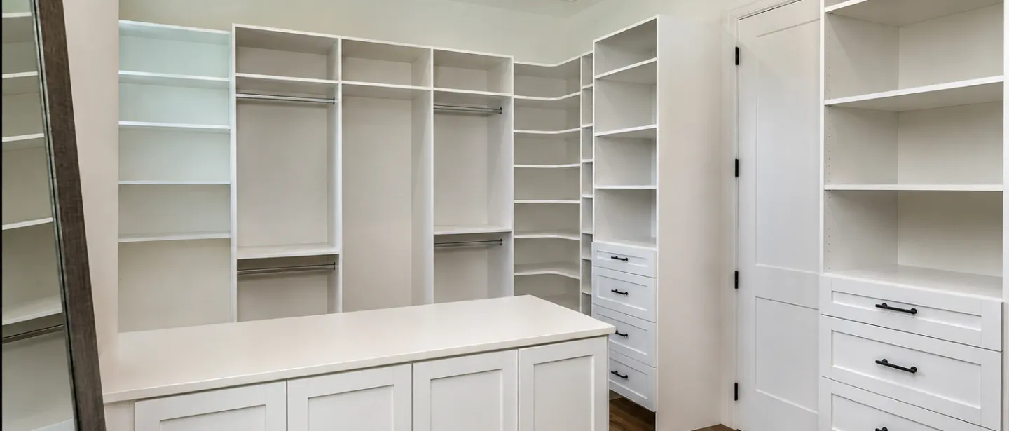 Large custom walk-in closet with built-ins, drawers, and center island