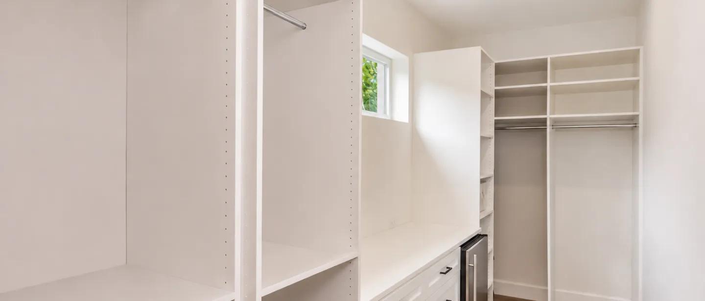 Spacious walk-in closet with custom built-ins and organized storage