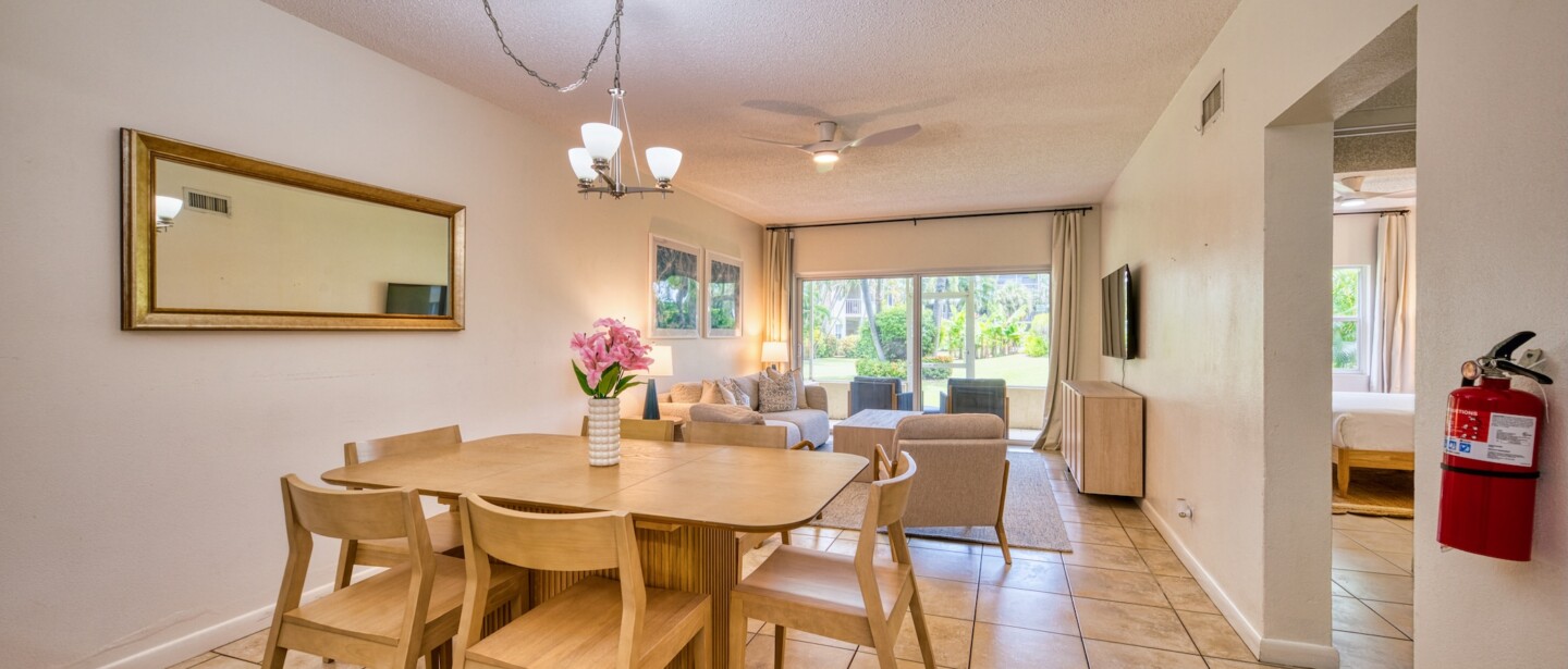 Bright open-plan dining and living space with garden-view patio doors