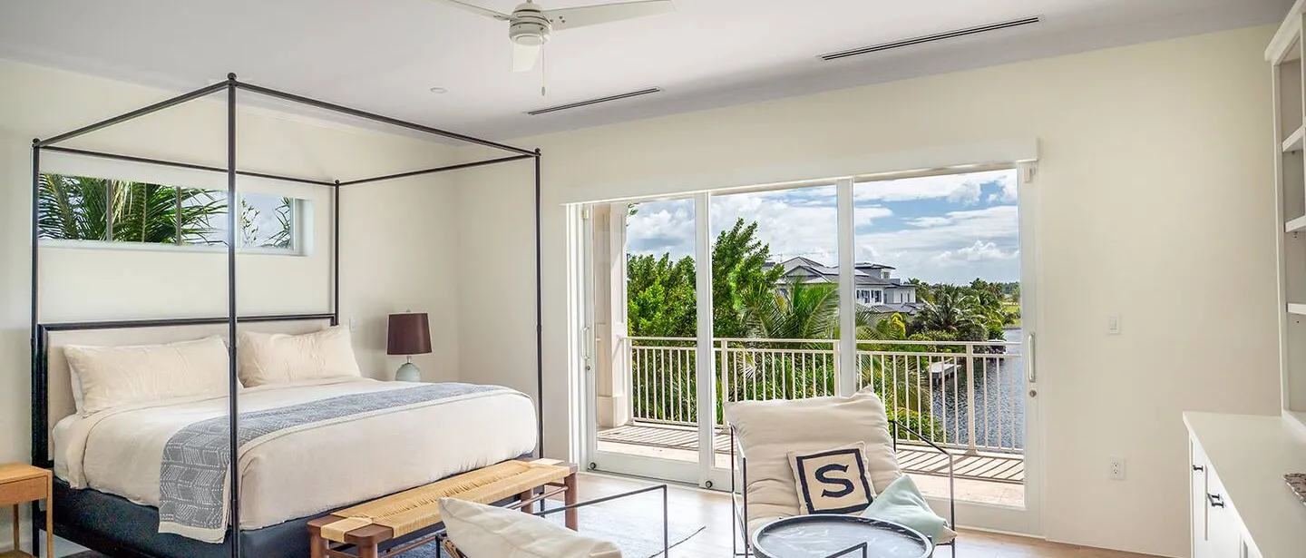 The upstairs master en suite with a balcony that overlooks the pool and canal.
