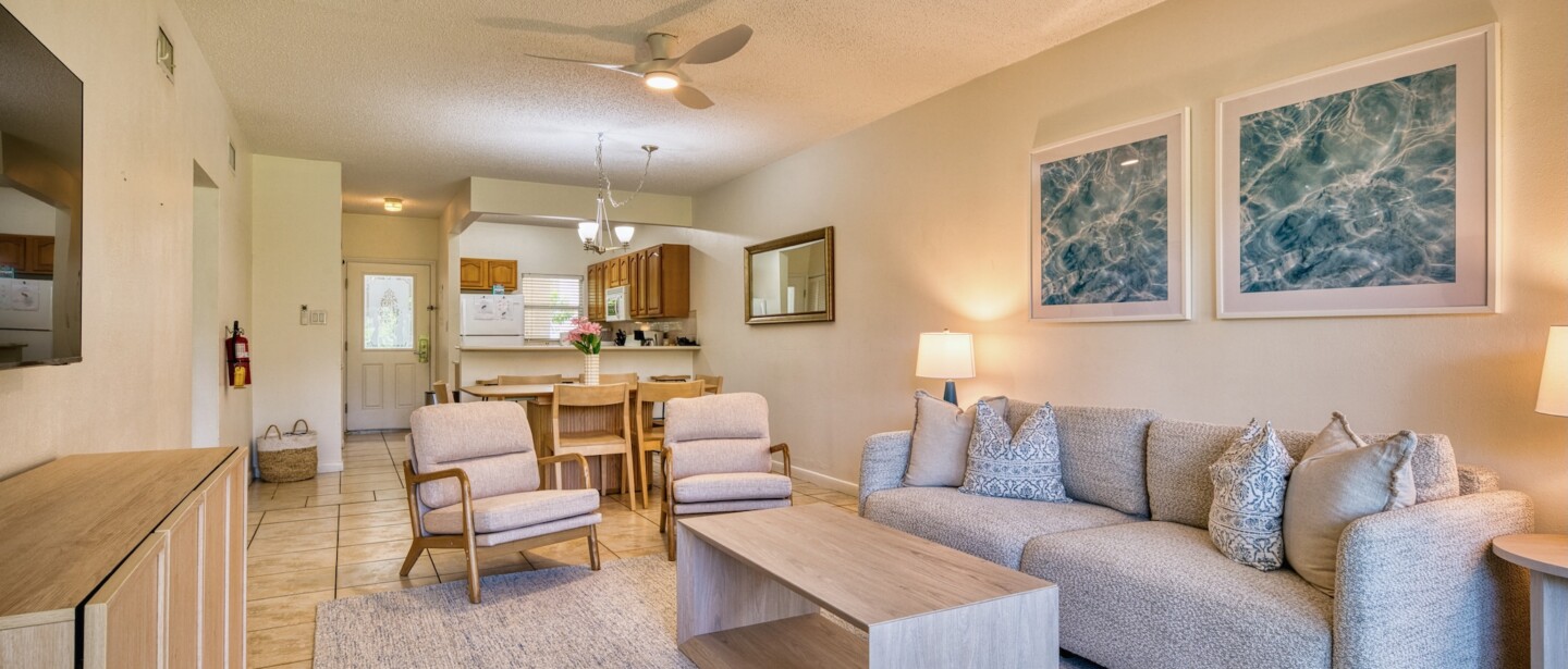 Bright open living space with cozy seating, dining area, and full kitchen