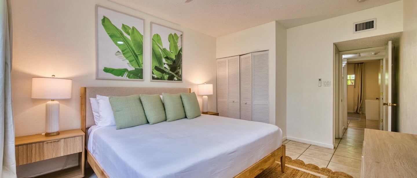 Bright tropical-style king bedroom with cozy natural wood accents