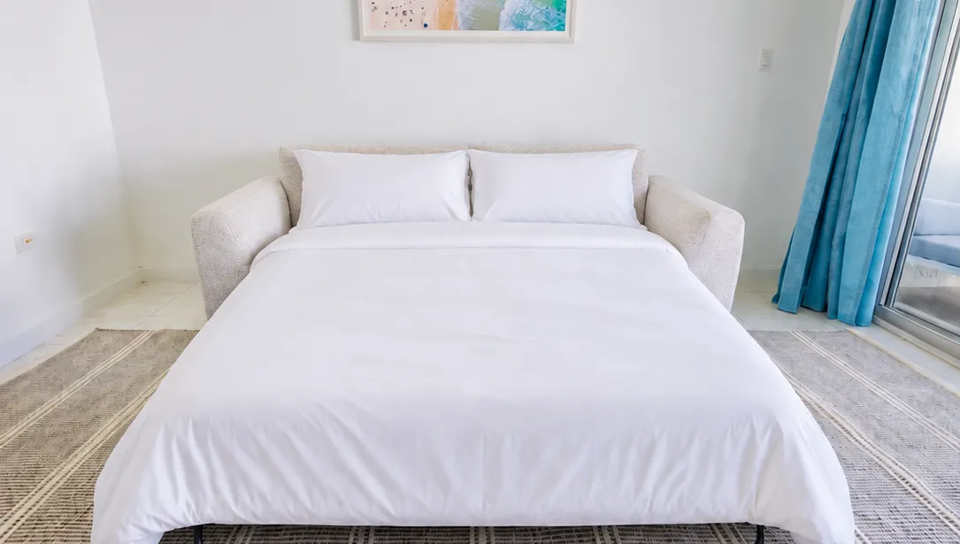 Bright coastal-style bedroom with crisp linens and a breezy, airy feel